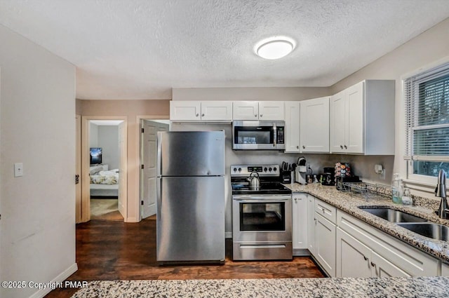 kitchen featuring sink, white cabinets, and appliances with stainless steel finishes