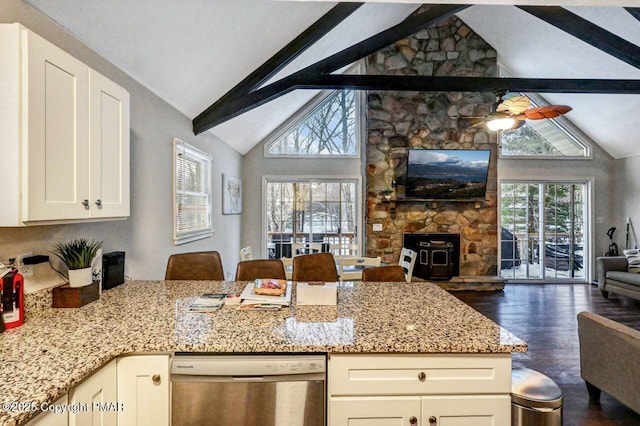 kitchen with lofted ceiling with beams, dishwasher, white cabinetry, ceiling fan, and light stone countertops