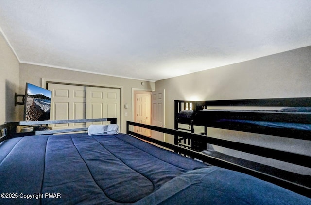 unfurnished bedroom featuring crown molding and a closet