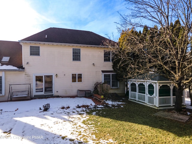 snow covered property featuring a yard