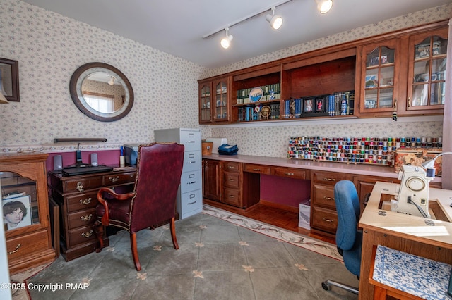 tiled home office with wallpapered walls and built in desk