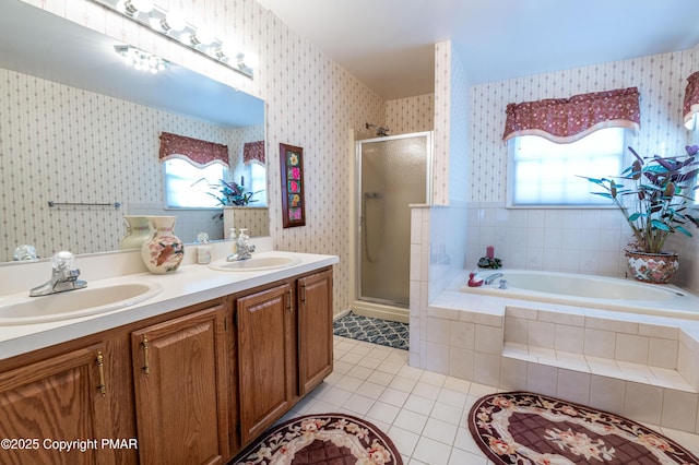 full bathroom featuring a stall shower, tile patterned floors, a sink, and wallpapered walls