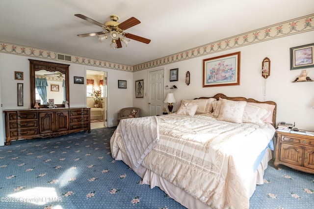 carpeted bedroom featuring ensuite bathroom and ceiling fan