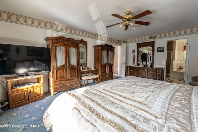 carpeted bedroom featuring lofted ceiling, ensuite bath, ceiling fan, and visible vents