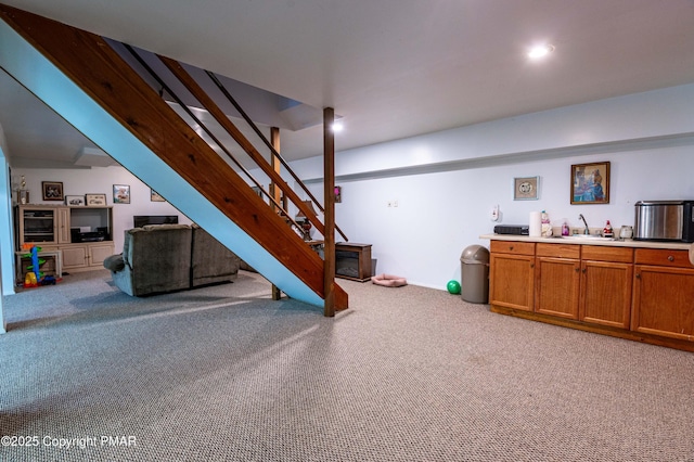 interior space with stairs, light carpet, a sink, and recessed lighting