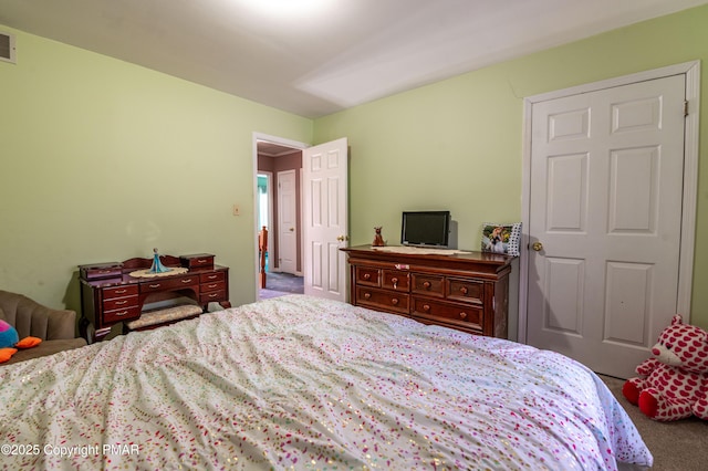 carpeted bedroom featuring visible vents