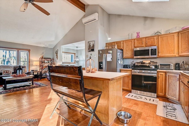 kitchen featuring open floor plan, stainless steel appliances, a wall mounted air conditioner, and light countertops