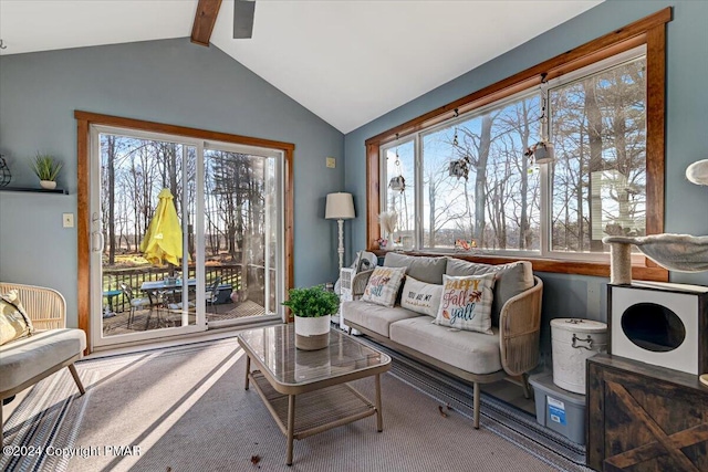 sitting room with vaulted ceiling with beams and carpet flooring