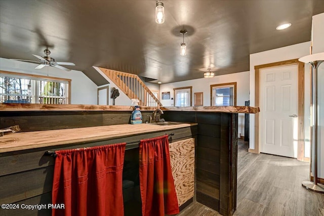 kitchen featuring wood finished floors, a sink, and a ceiling fan