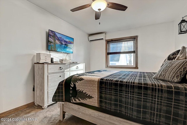 bedroom with a ceiling fan, carpet, a wall mounted air conditioner, and baseboards