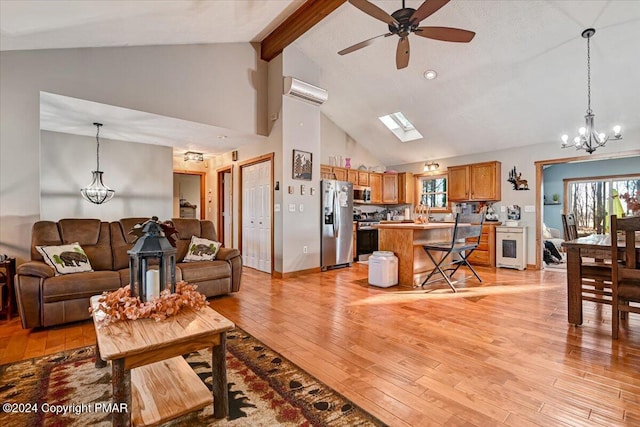 living room featuring an AC wall unit, beamed ceiling, a wealth of natural light, and light wood-style floors