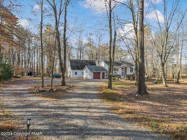 view of front of house with gravel driveway and an attached garage