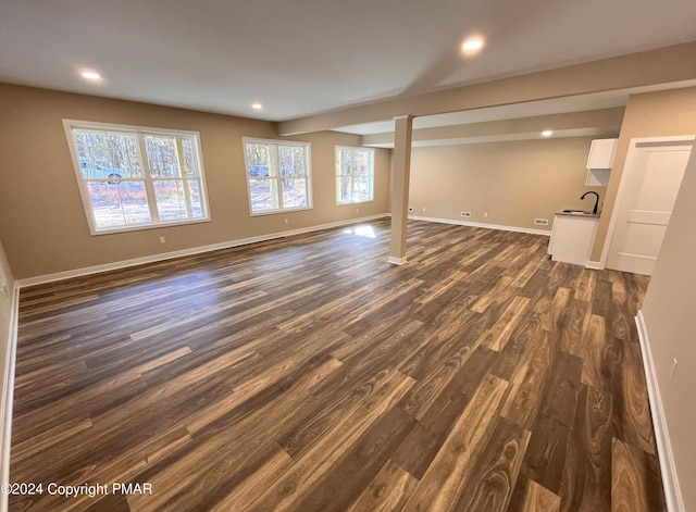 basement featuring recessed lighting, baseboards, and dark wood-style flooring