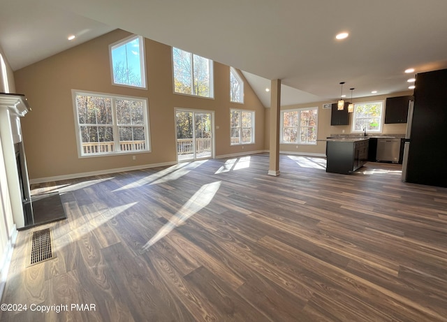 unfurnished living room with dark wood finished floors, decorative columns, visible vents, baseboards, and recessed lighting