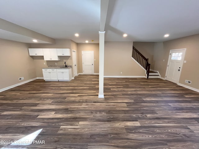 unfurnished living room featuring dark wood-style floors, a sink, and recessed lighting