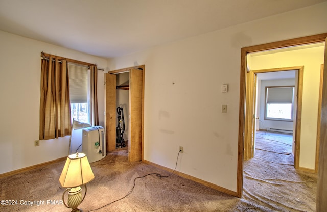 interior space featuring baseboards and a baseboard heating unit