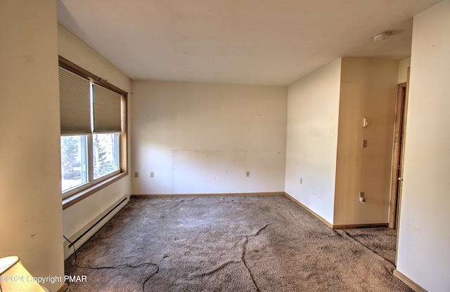 carpeted empty room featuring baseboards and baseboard heating