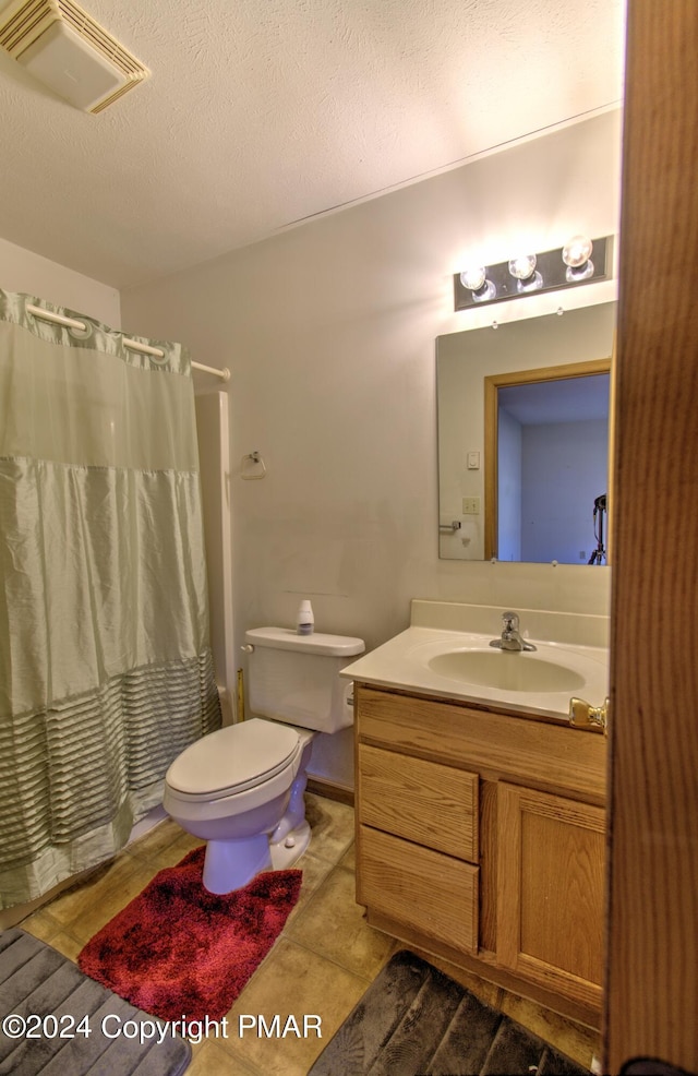 bathroom featuring visible vents, toilet, a textured ceiling, vanity, and a shower with curtain