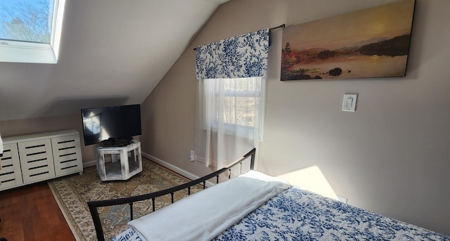 bedroom featuring vaulted ceiling, wood finished floors, and baseboards