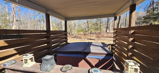 wooden terrace featuring a hot tub