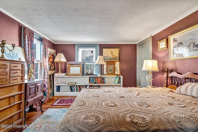 bedroom with crown molding, a textured ceiling, and wood finished floors