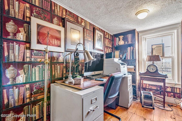 office featuring a textured ceiling, ornamental molding, and hardwood / wood-style flooring