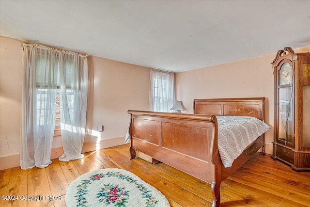 bedroom featuring light wood-style flooring and baseboards