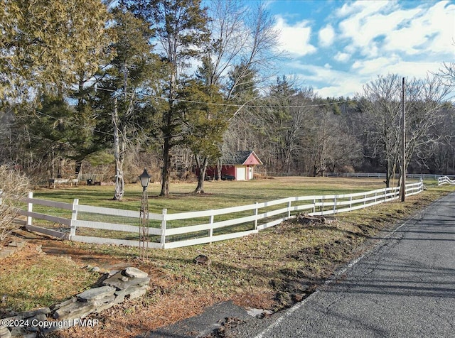 view of street with a forest view and a rural view