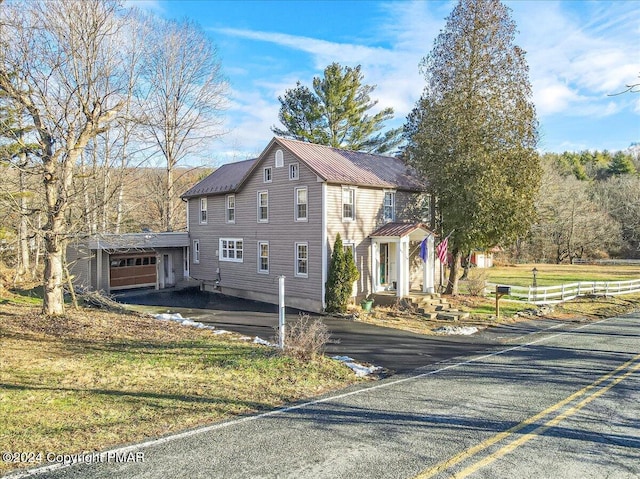 view of side of home with metal roof and fence