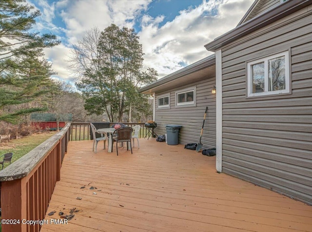 wooden terrace featuring outdoor dining area