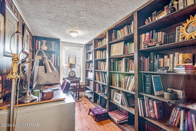 office space with a textured ceiling and hardwood / wood-style flooring