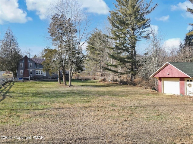 view of yard featuring a detached garage and fence