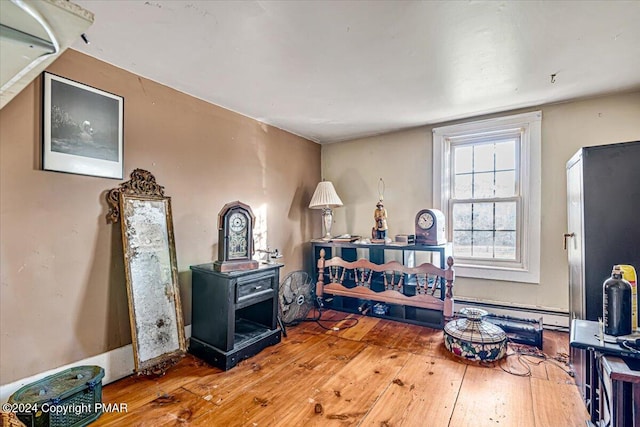 interior space with baseboard heating and wood-type flooring