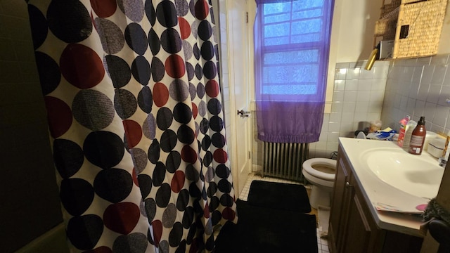 bathroom featuring a shower with curtain, tile walls, vanity, toilet, and radiator
