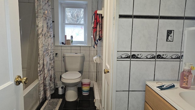 full bathroom featuring tile walls, tile patterned floors, vanity, toilet, and shower / bath combo with shower curtain