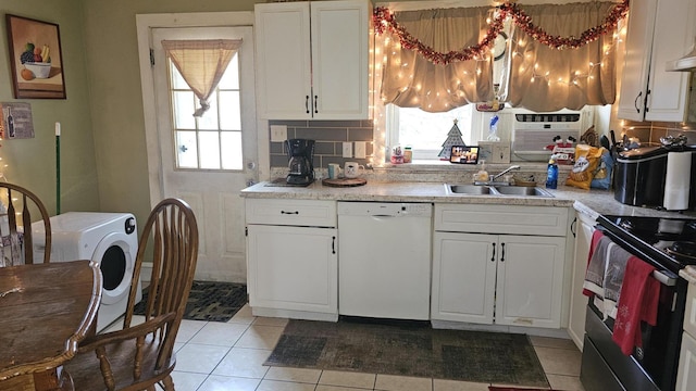kitchen with electric range, white dishwasher, a sink, and a healthy amount of sunlight