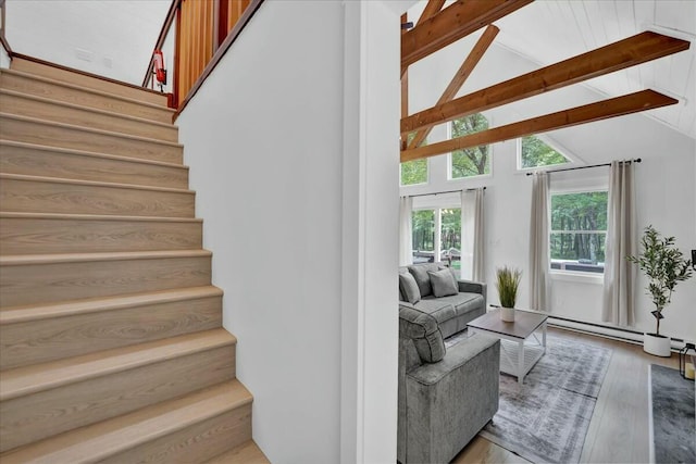 staircase featuring high vaulted ceiling, beamed ceiling, baseboard heating, and wood finished floors