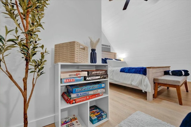 bedroom with vaulted ceiling, wood finished floors, and a ceiling fan