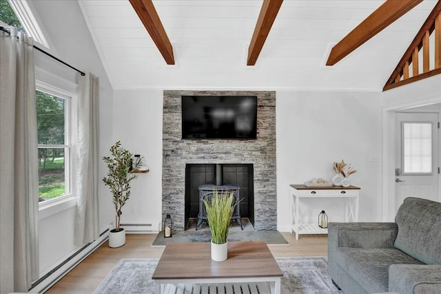 living room featuring a wealth of natural light, vaulted ceiling with beams, and wood finished floors