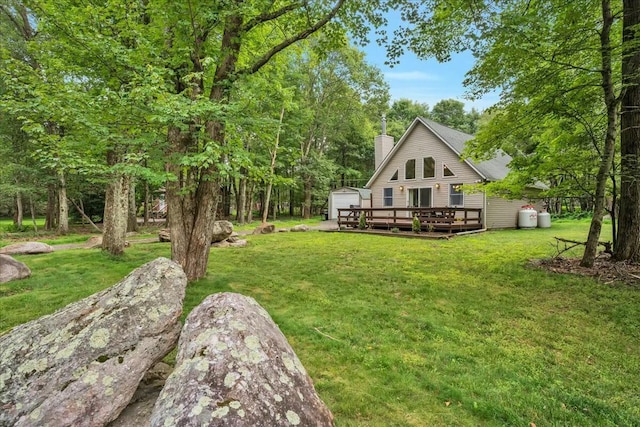 view of yard with a deck and an outdoor structure