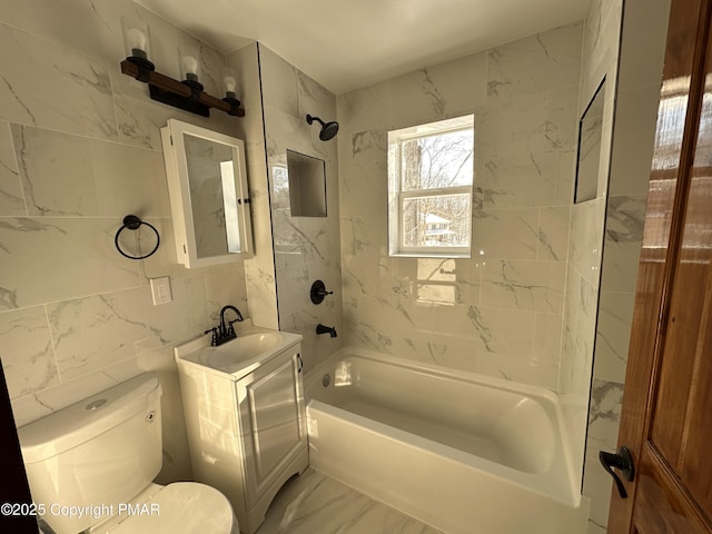 full bath featuring toilet, vanity, tile walls, marble finish floor, and tub / shower combination