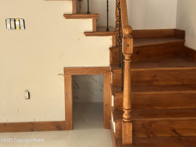 staircase with tile patterned floors