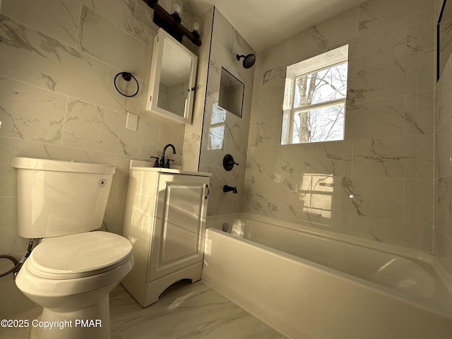 bathroom with toilet, marble finish floor, vanity, and bathing tub / shower combination