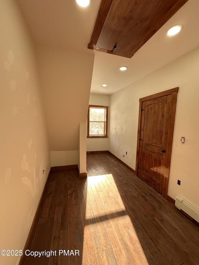 bonus room with a baseboard radiator, wood-type flooring, baseboards, and recessed lighting