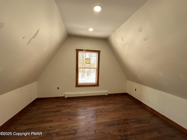 additional living space with a baseboard radiator, lofted ceiling, baseboards, and wood finished floors