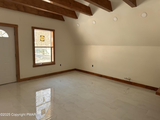 additional living space featuring marble finish floor, vaulted ceiling with beams, and baseboards