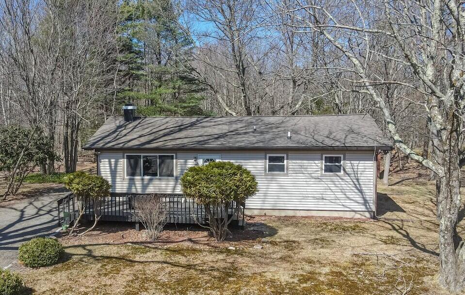 view of side of property featuring a wooden deck