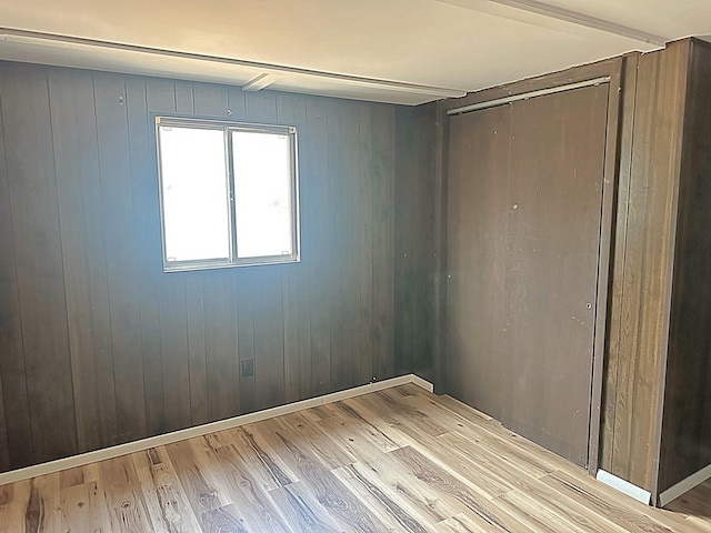 spare room featuring wood finished floors