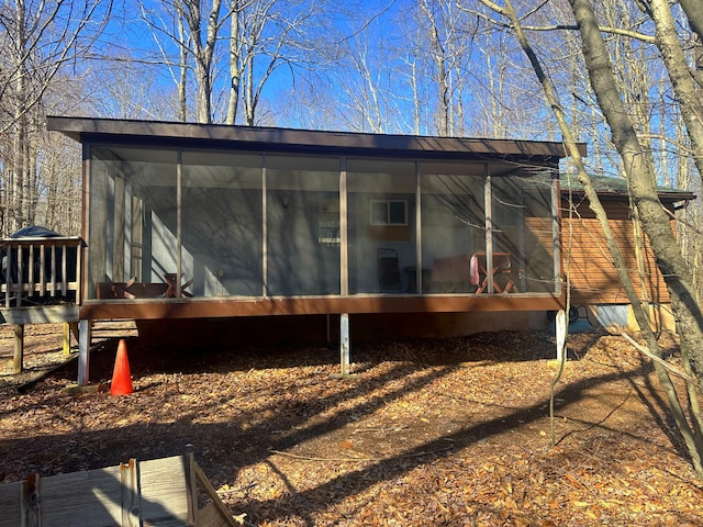 back of property with a sunroom