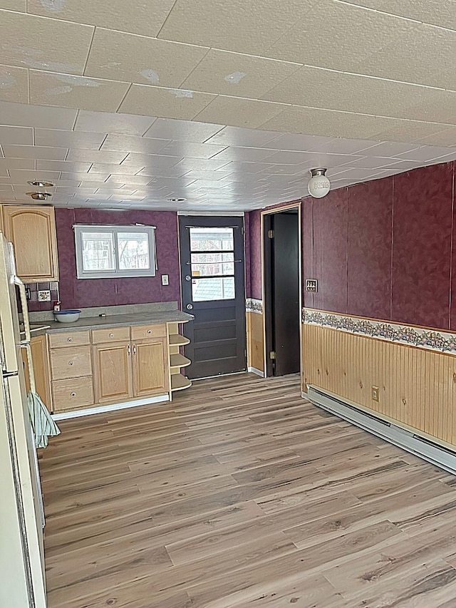 kitchen featuring wooden walls, light brown cabinets, light wood-style floors, and open shelves